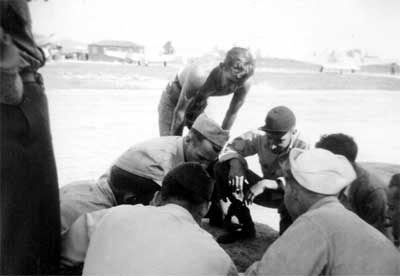 Ltjg. Sybeldon playing black-jack with crew